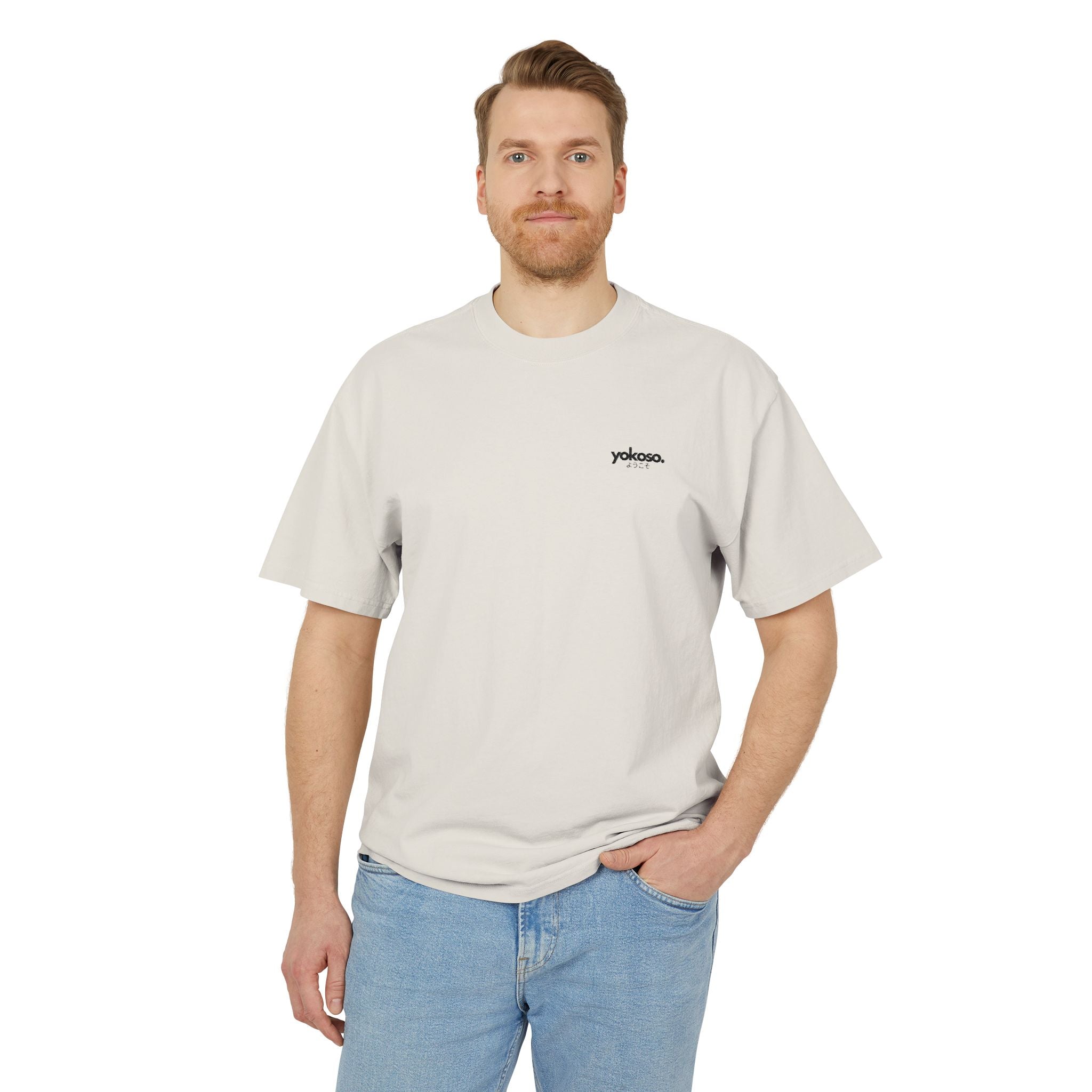Man wearing a beige t-shirt with a logo on a white background